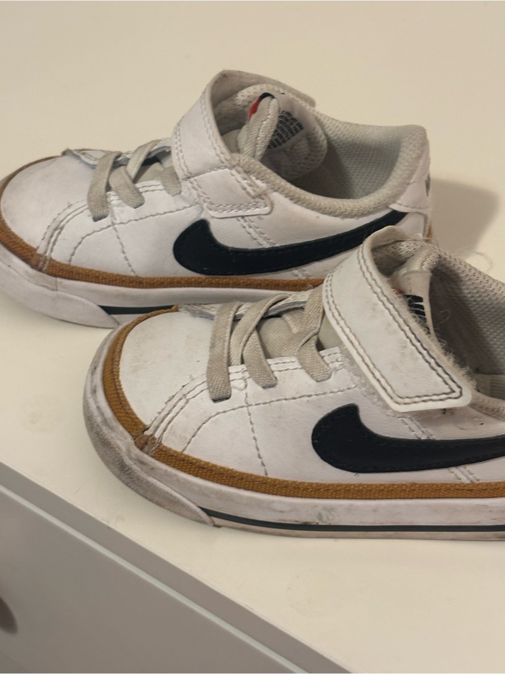 Nike Kids White Sneakers with Black Swoosh and Brown Trim